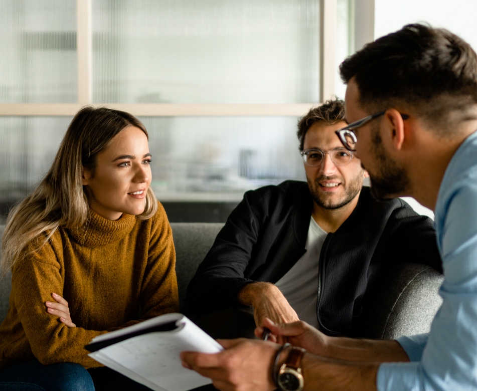 A coach explaining techniques to two clients.